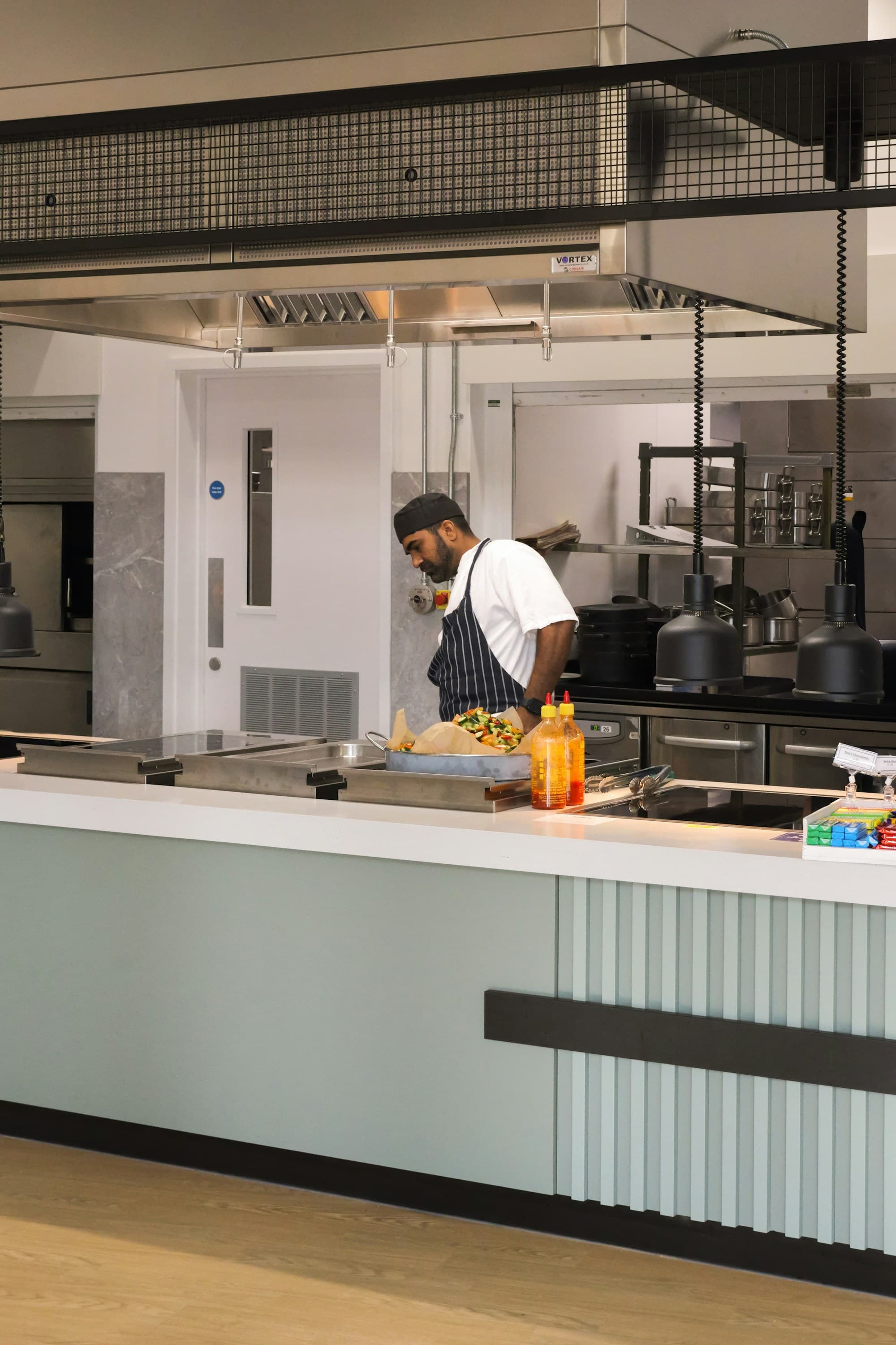 A chef working in a bright commercial kitchen